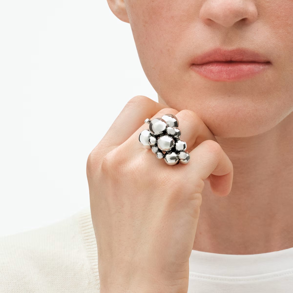 Large silver ring on hand 