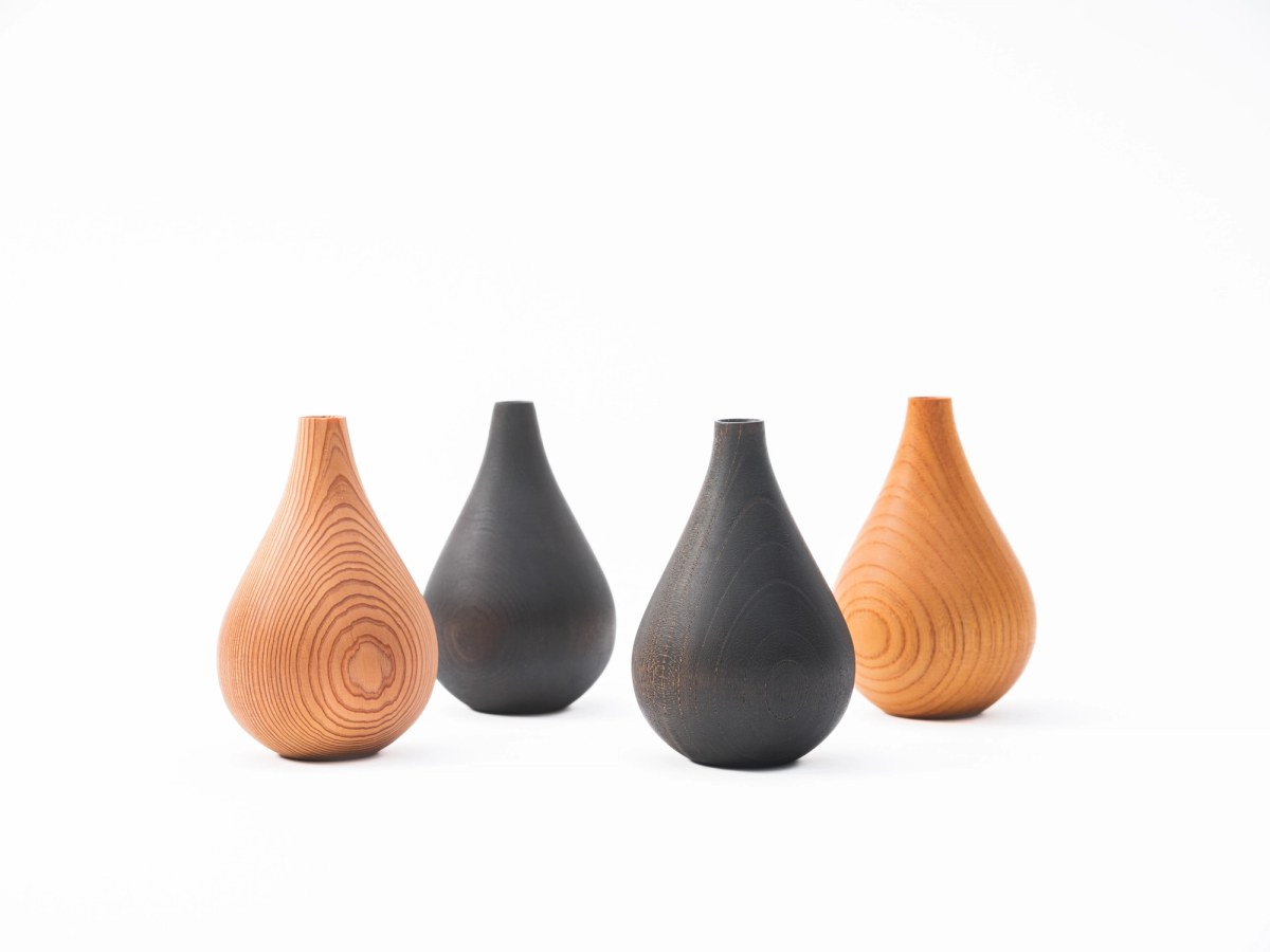Four small wooden vases