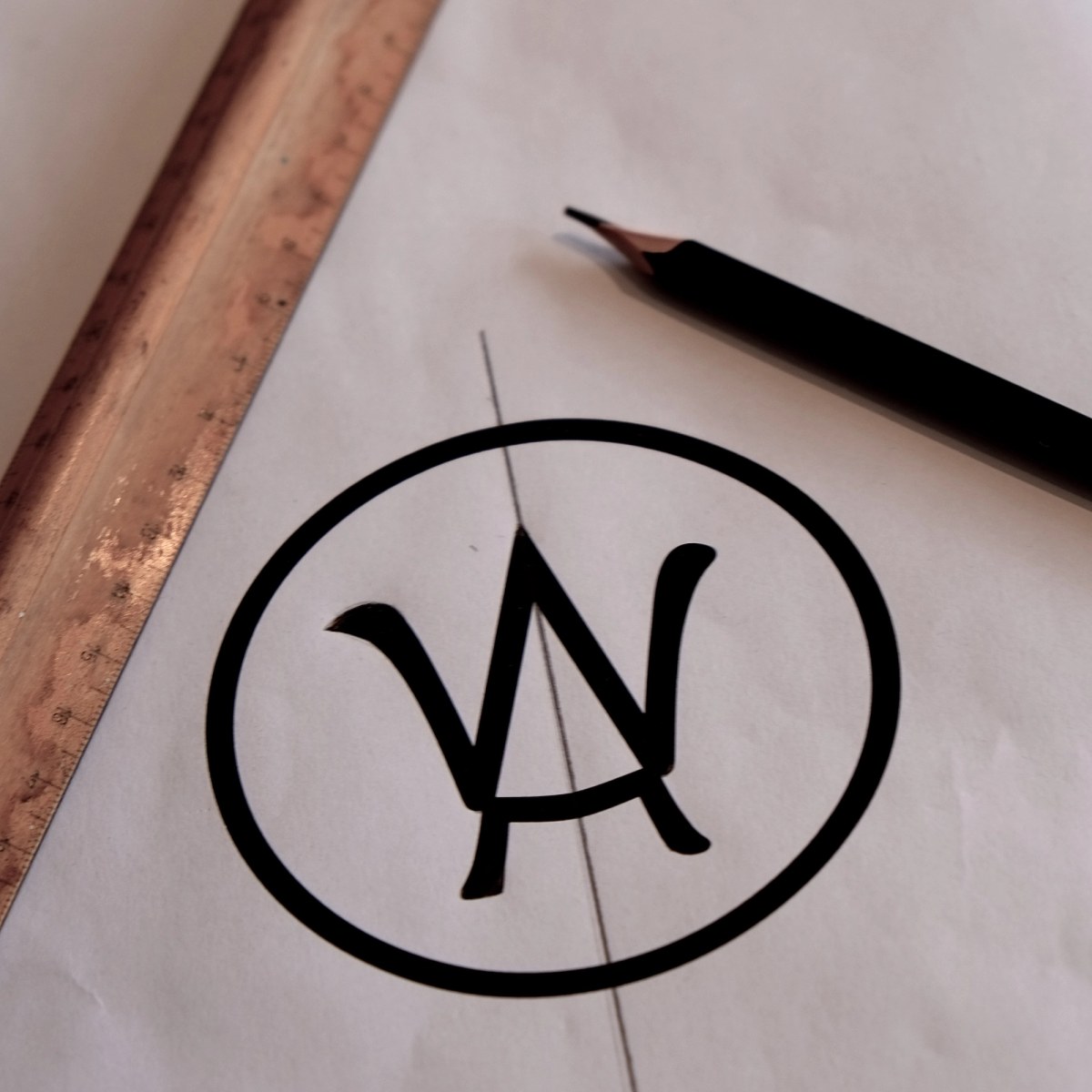 Stellar Works logo on white paper with pen and brass ruler