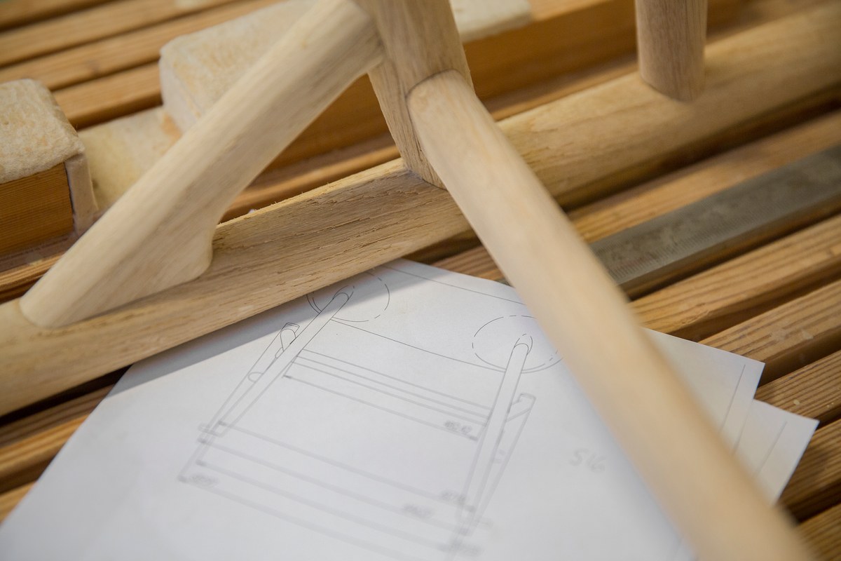 Wooden chair legs on white paper drawing