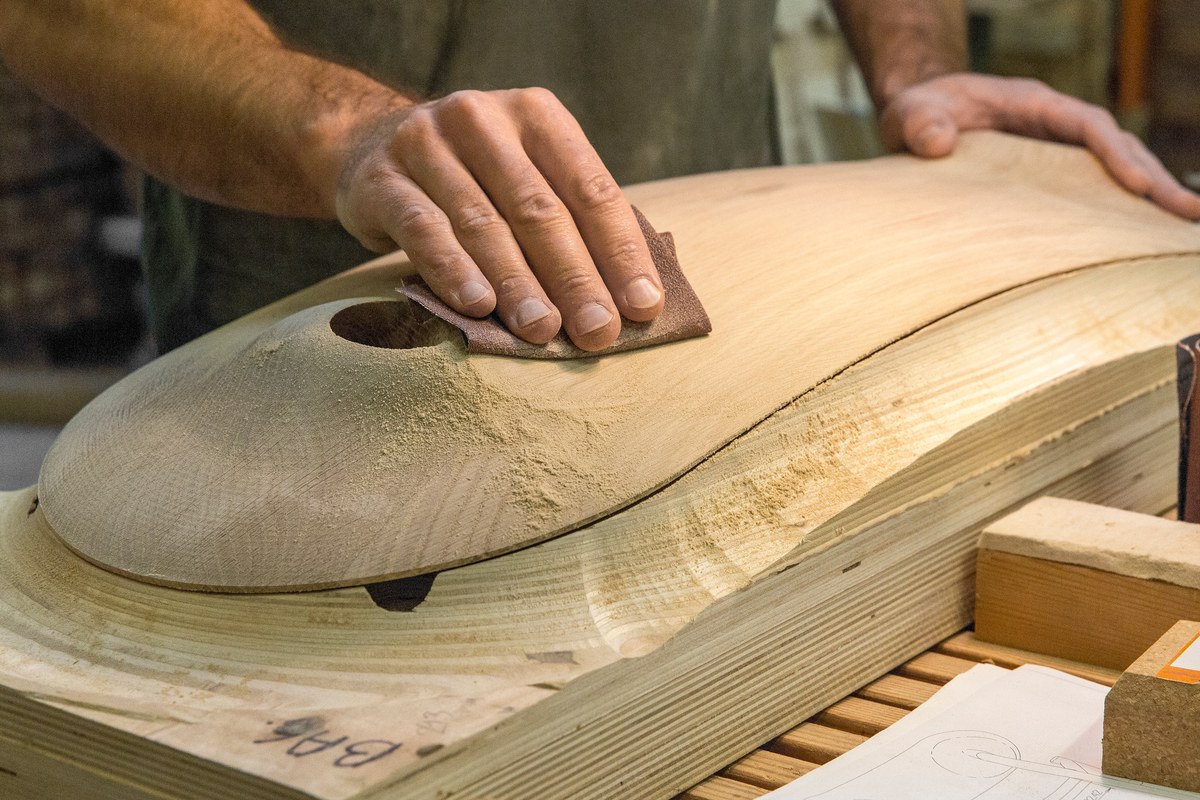 Wooden backrest sanded by hand at factory facility