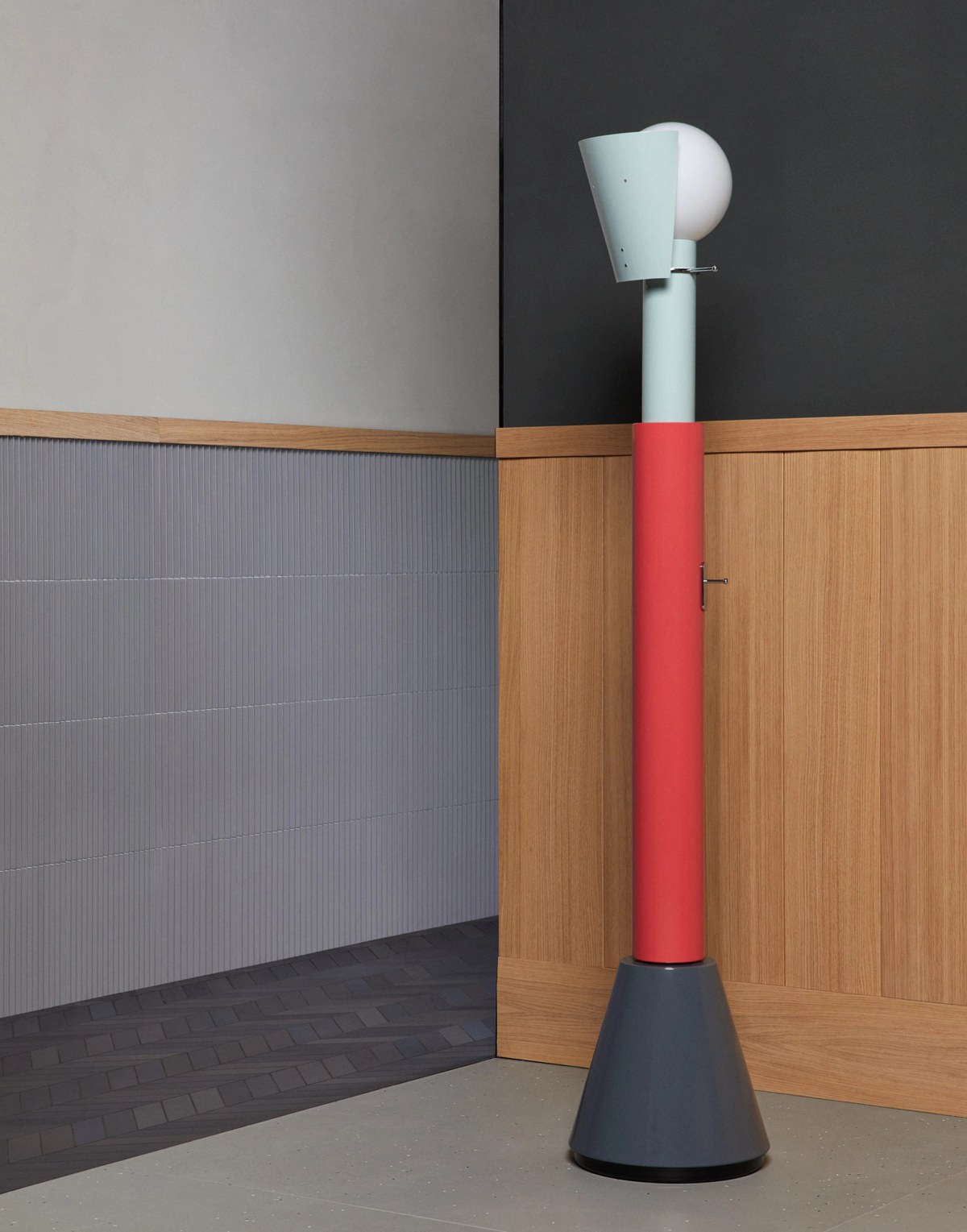 High ceramic art piece in front of tiled walls and high wooden wall panelling