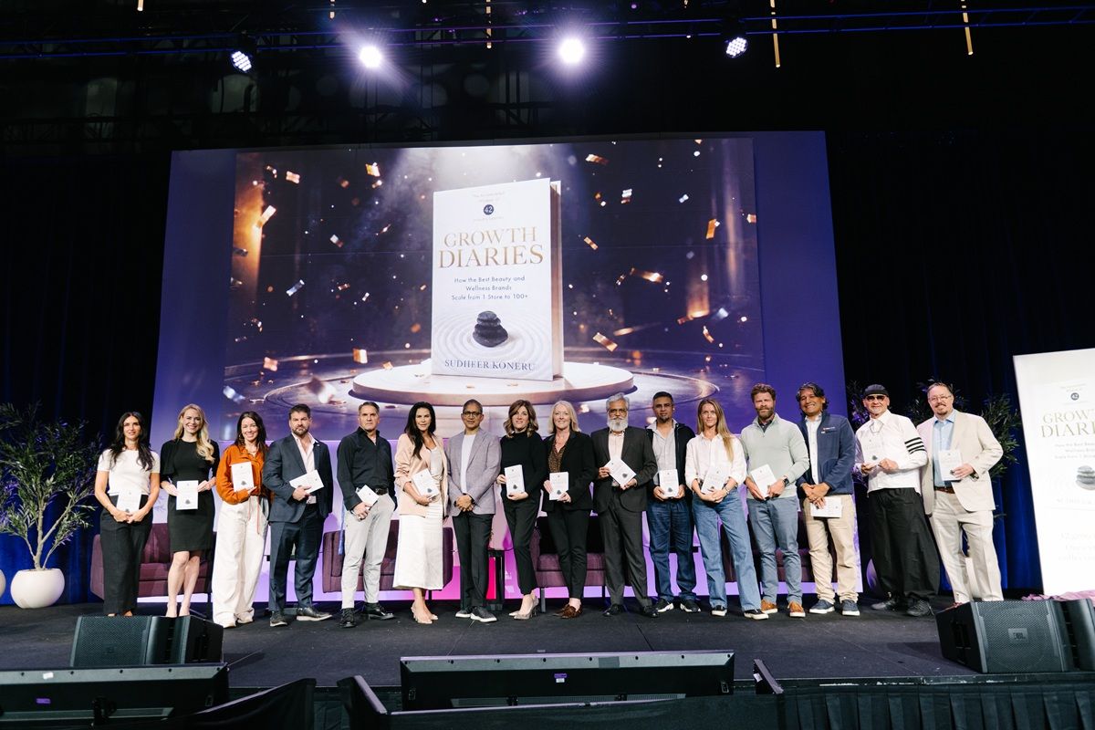 Sudheer Koneru, CEO of Zenoti, celebrates the launch of Growth Diaries at Innergize 2026, joined onstage by featured founders and industry leaders behind the book.