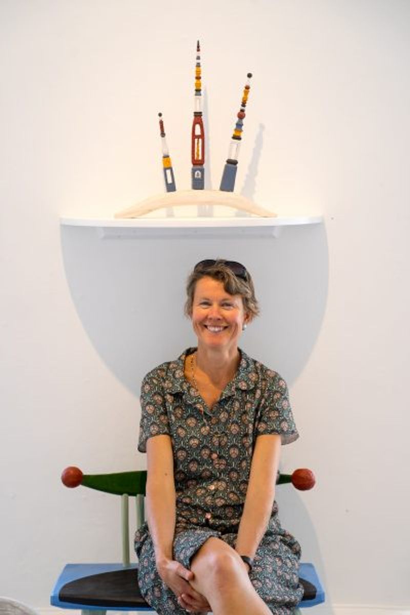 Besökare Karin sittande på Bära frukt. Rockhuvuden Slöjdivism,