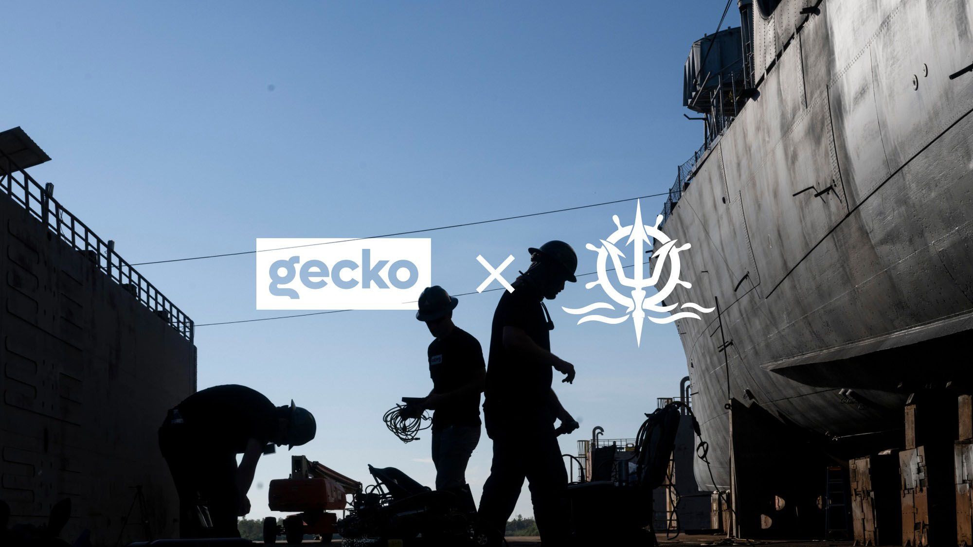 Gecko and Trident logos over workers silhouetted beside a ship’s hull in dry dock