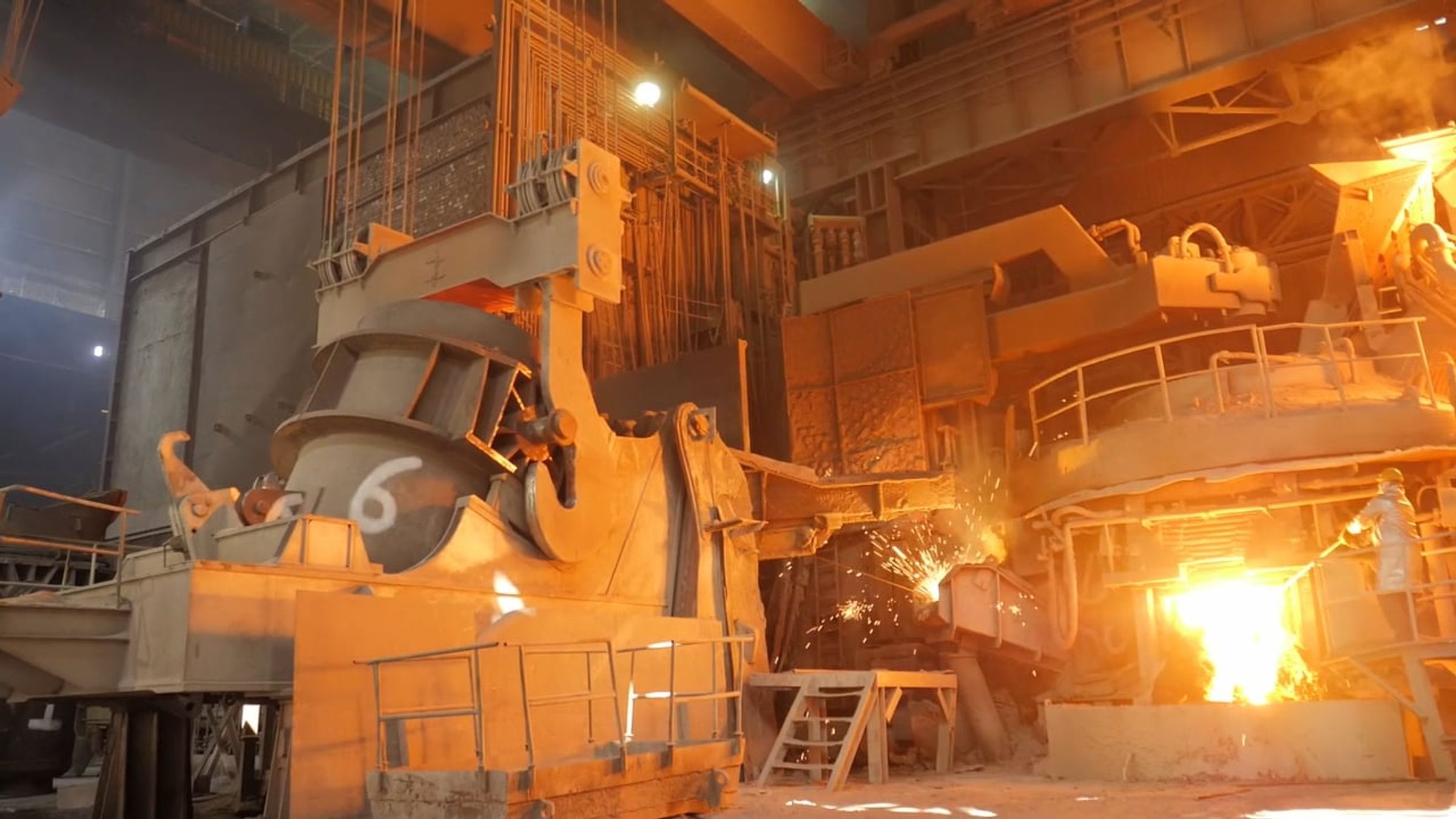 Molten metal and sparks at a steel mill furnace
