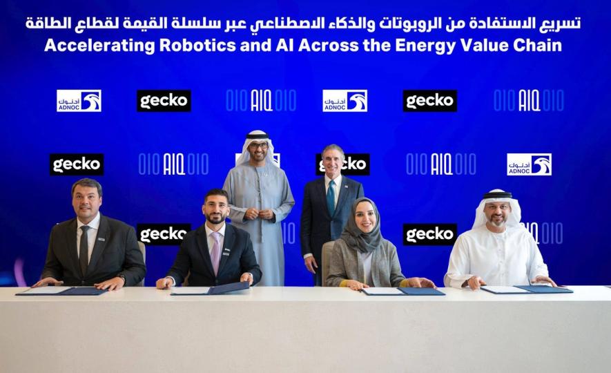 ADNOC, AIQ and Gecko representatives signing agreements under the banner Accelerating Robotics and AI Across the Energy Value Chain