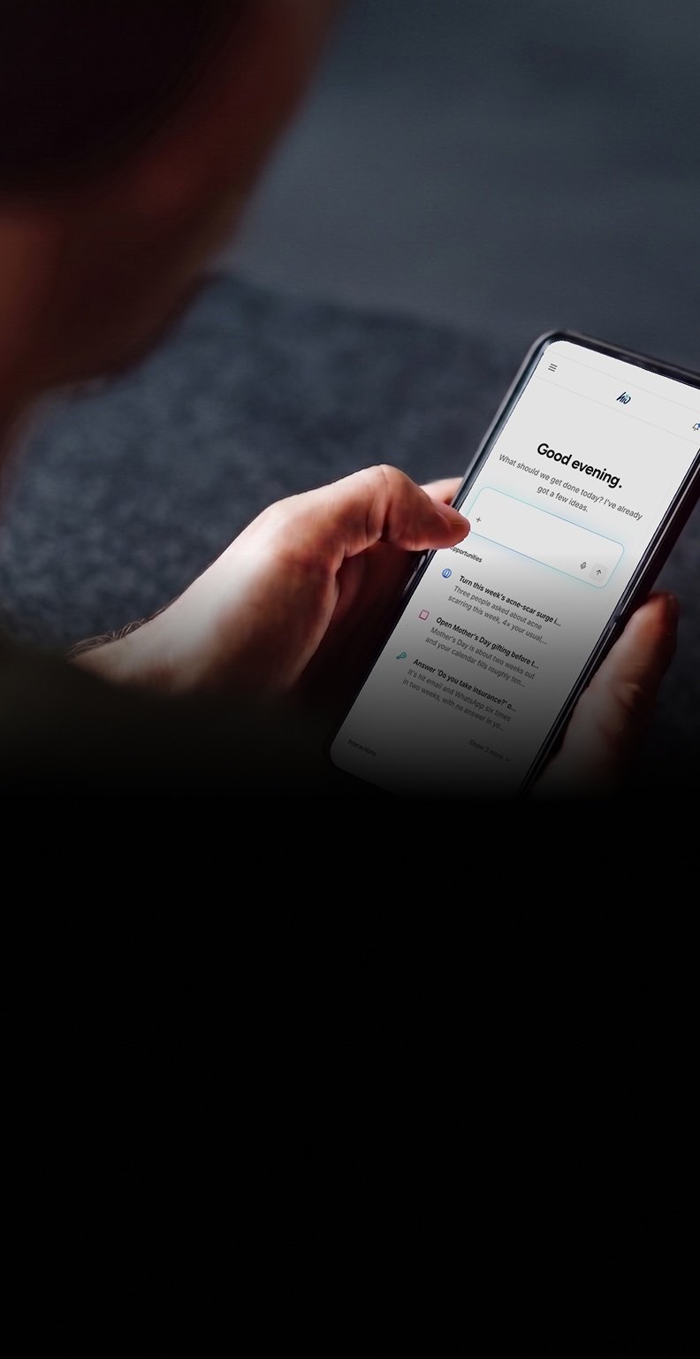 A business owner reviewing hio's suggested replies on their phone