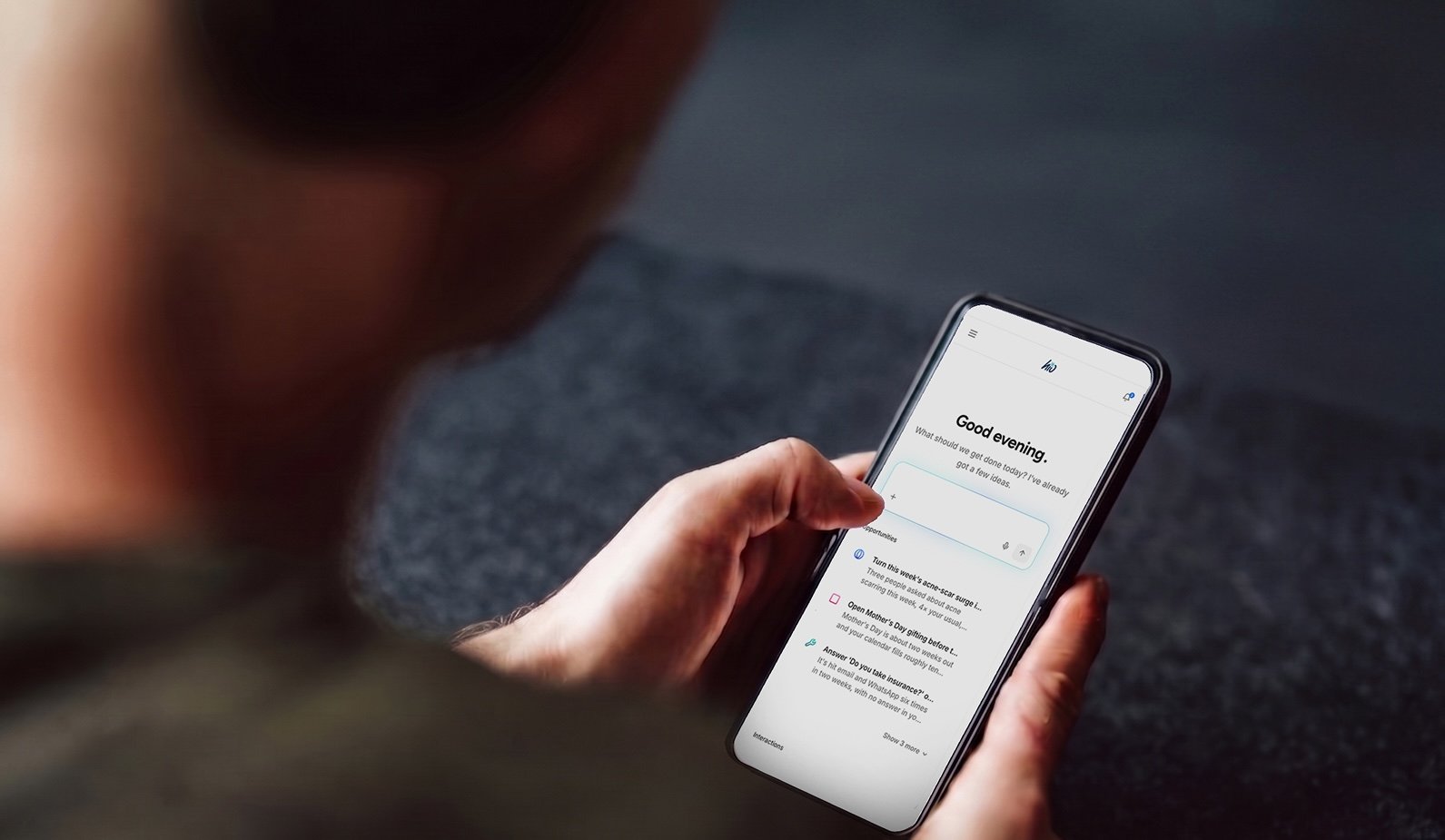 A business owner reviewing hio's suggested replies on their phone