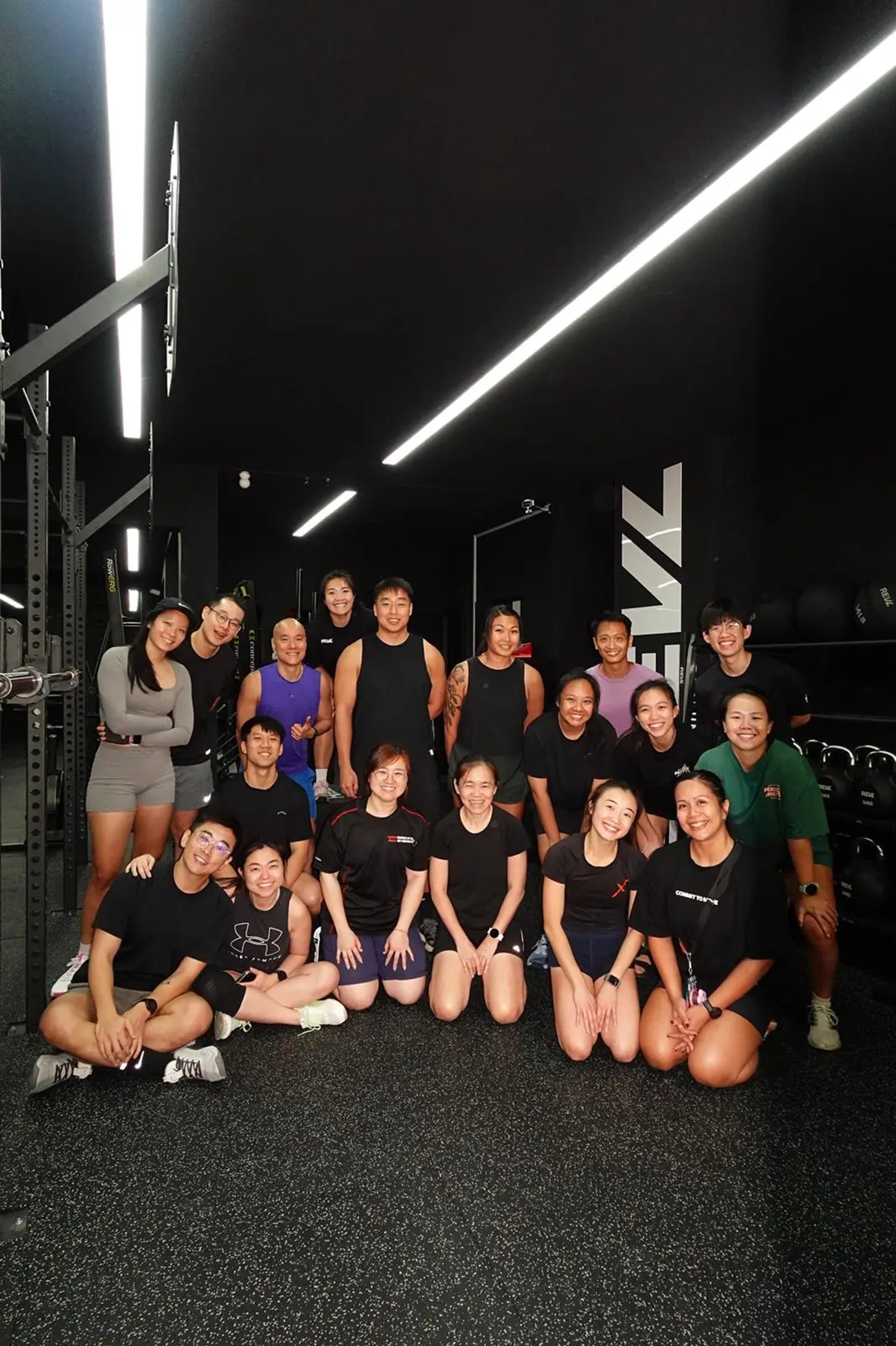 ActiveX Physiotherapy's Isabelle leading a mobility workshop for gym members and personal trainers at REVL gym Seletar Singapore, group photo in a strength and conditioning facility