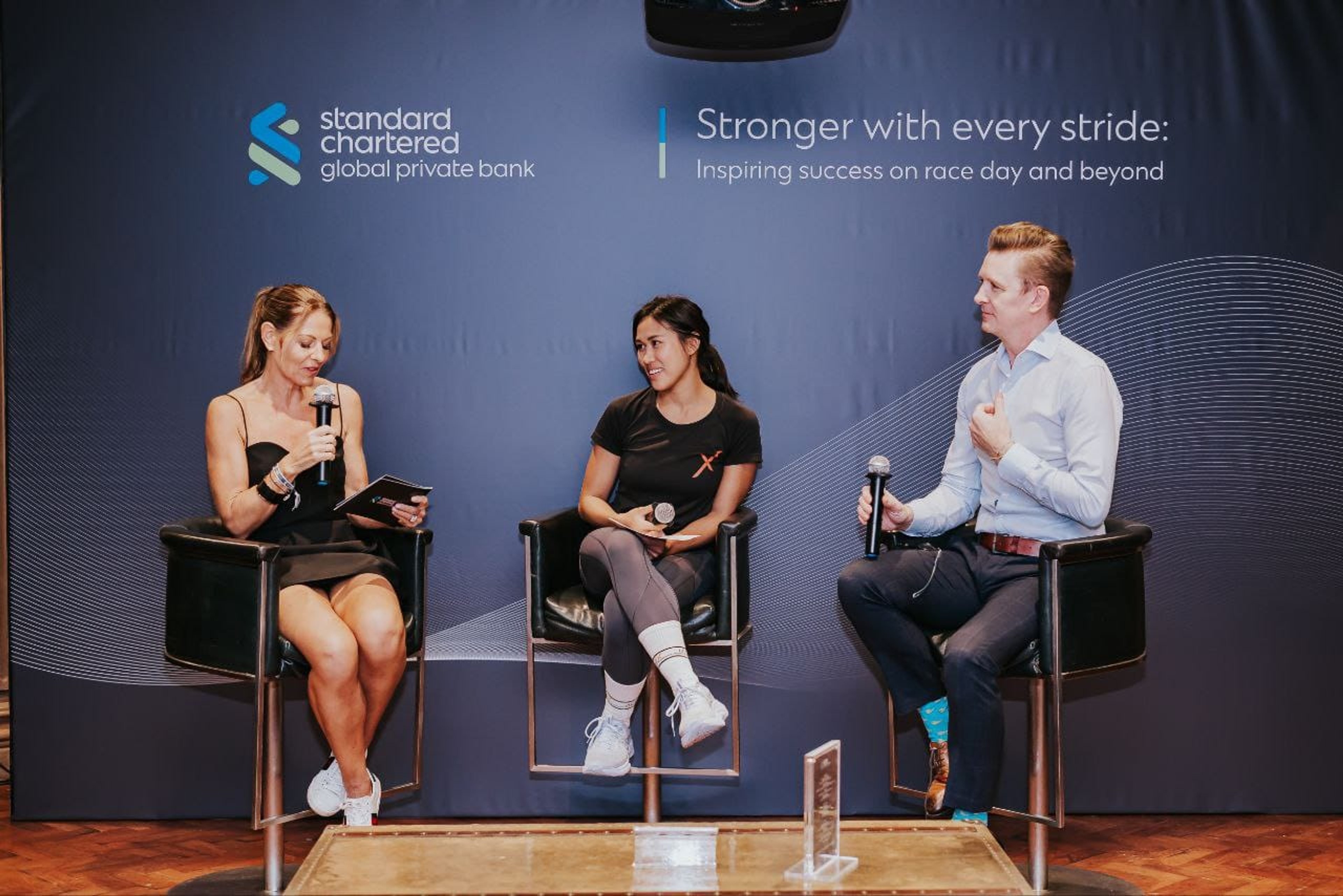 Helen Nguyen speaking at Standard Chartered Marathon Panel 2025