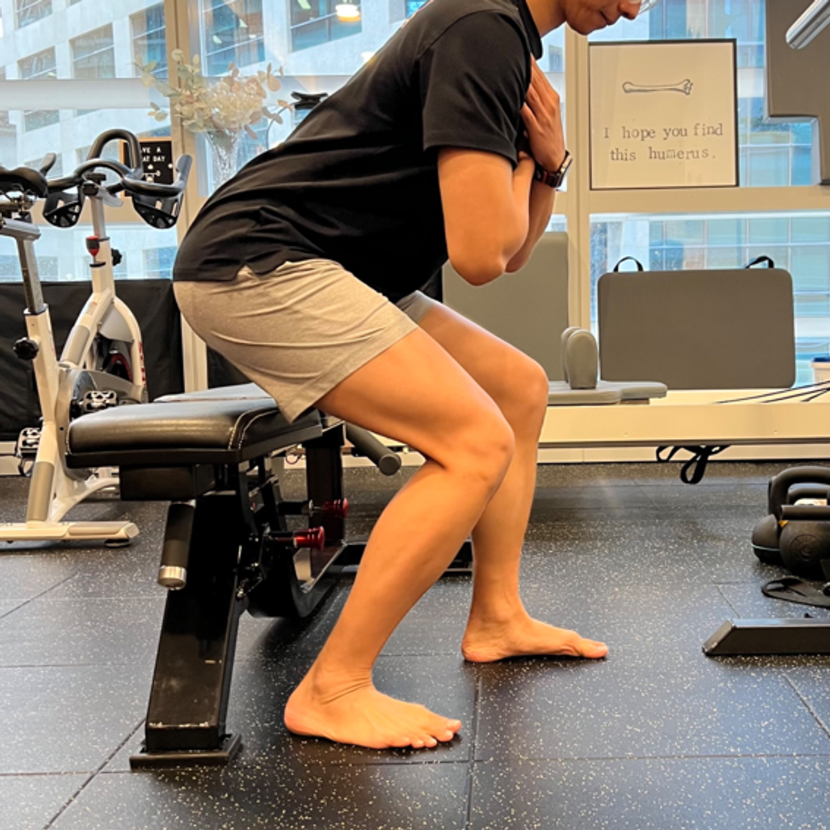 Squat variation biasing load toward the recovering leg.