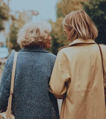 An older adult discussing hearing support with a care advocate