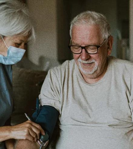 An older adult being supported by a care advocate at home