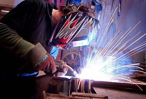 Man welding metal with sparks flying