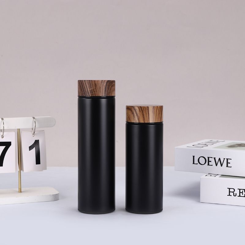 Black stainless steel vacuum insulated bottle with wood grain lid and tea filter