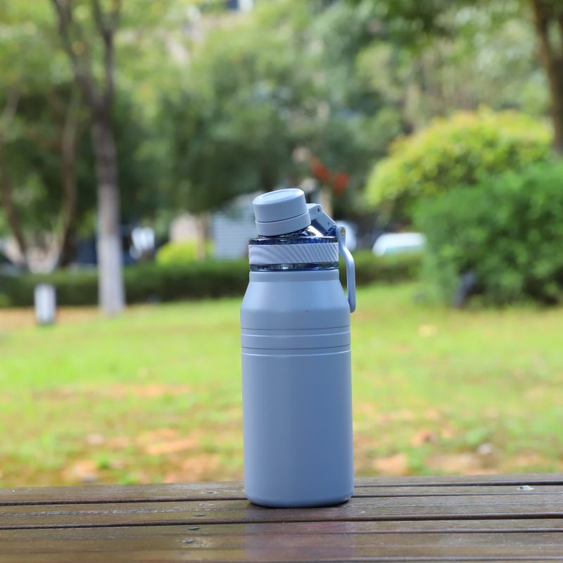light blue insulated water bottle with handle lid