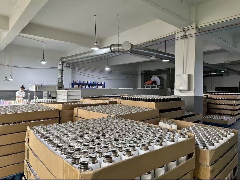 Factory production area with bulk stainless steel bottles arranged for processing