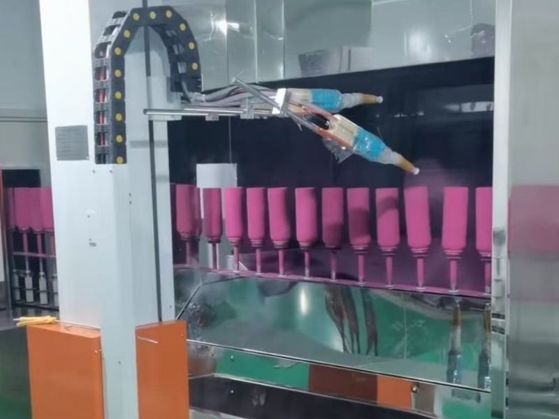 Automated spray coating machine painting stainless steel bottles on the factory production line