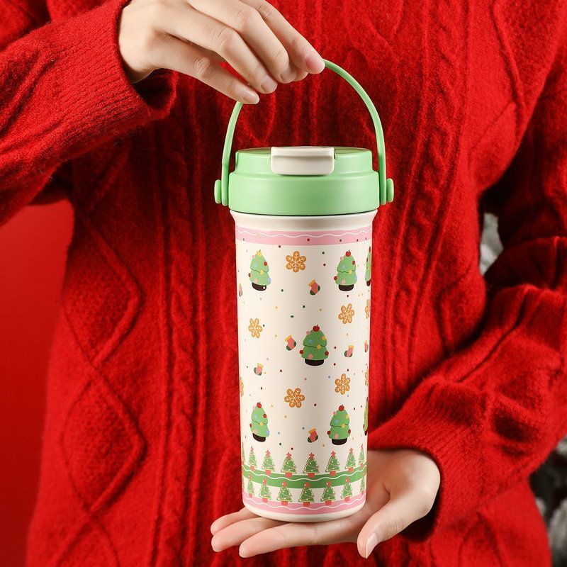 600ml Christmas insulated tumbler with handle and green lid featuring Christmas tree UV printed pattern