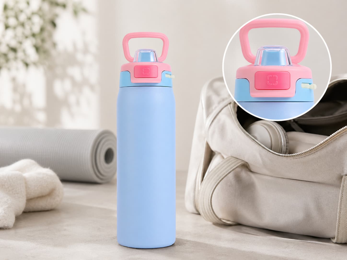 Pastel blue lockable leak-resistant bottle with close-up lid detail beside a gym bag and yoga mat