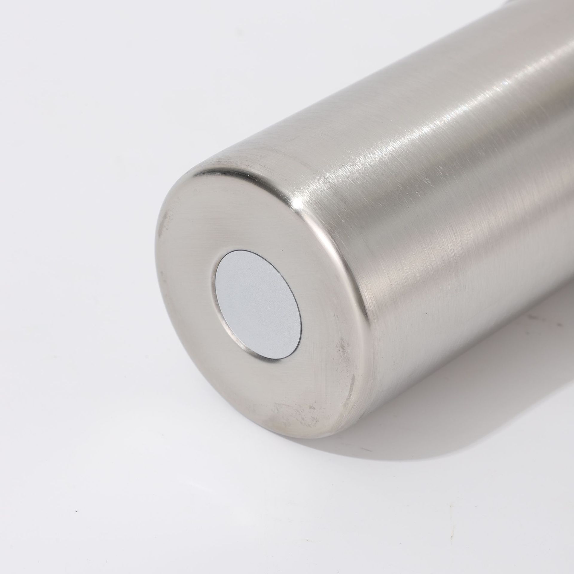 Stainless steel bottle base detail with round pad insert