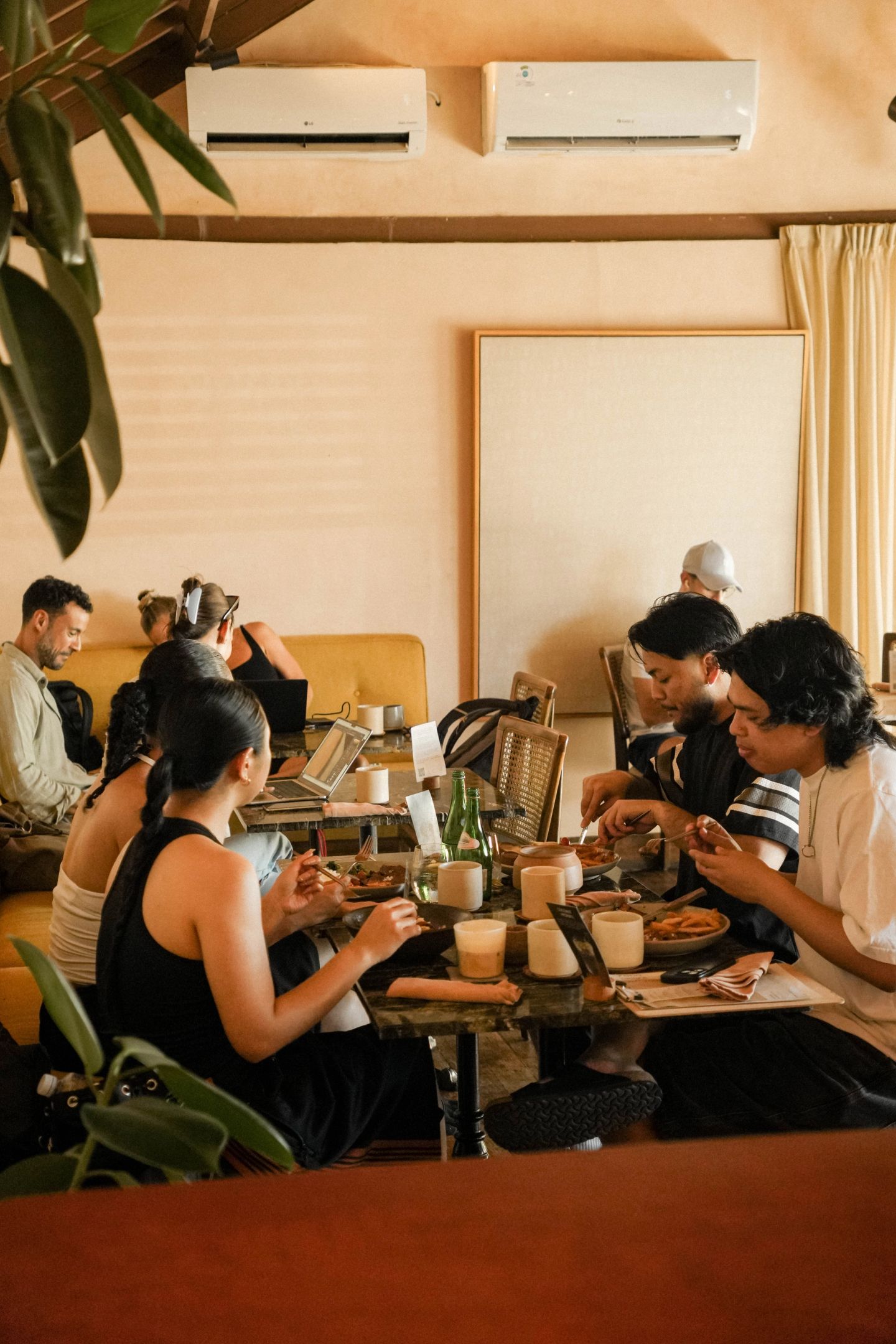 Guests sharing a meal together in the House of Sunday dining room, Batu Bolong