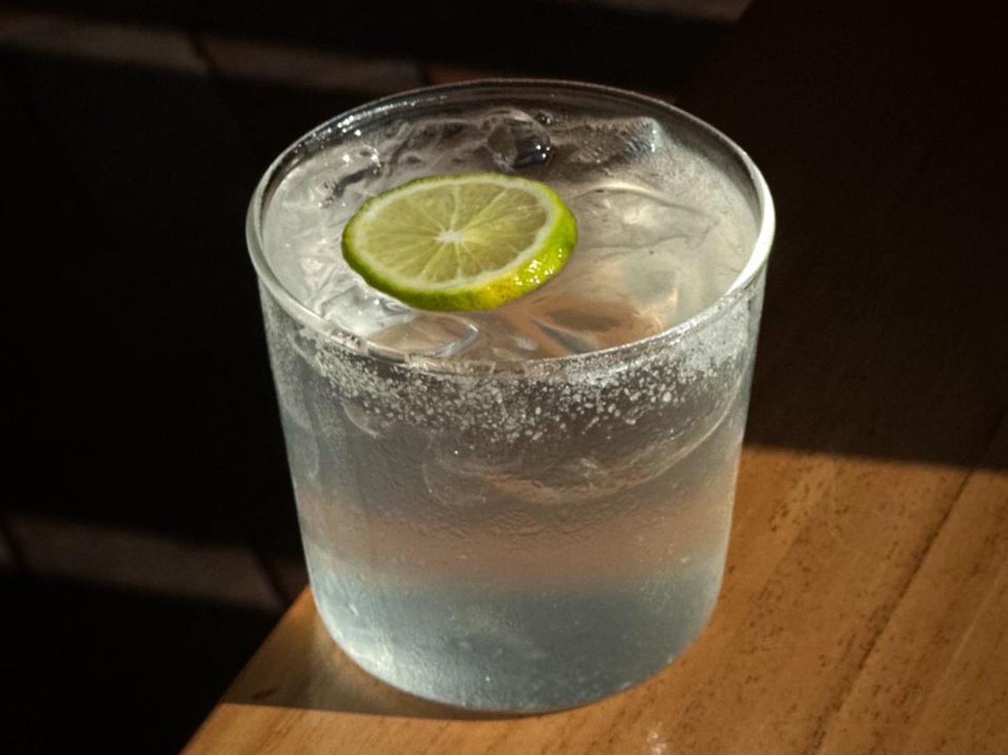 Fresh coconut water with lemon juice, served over ice with a citrus slice.