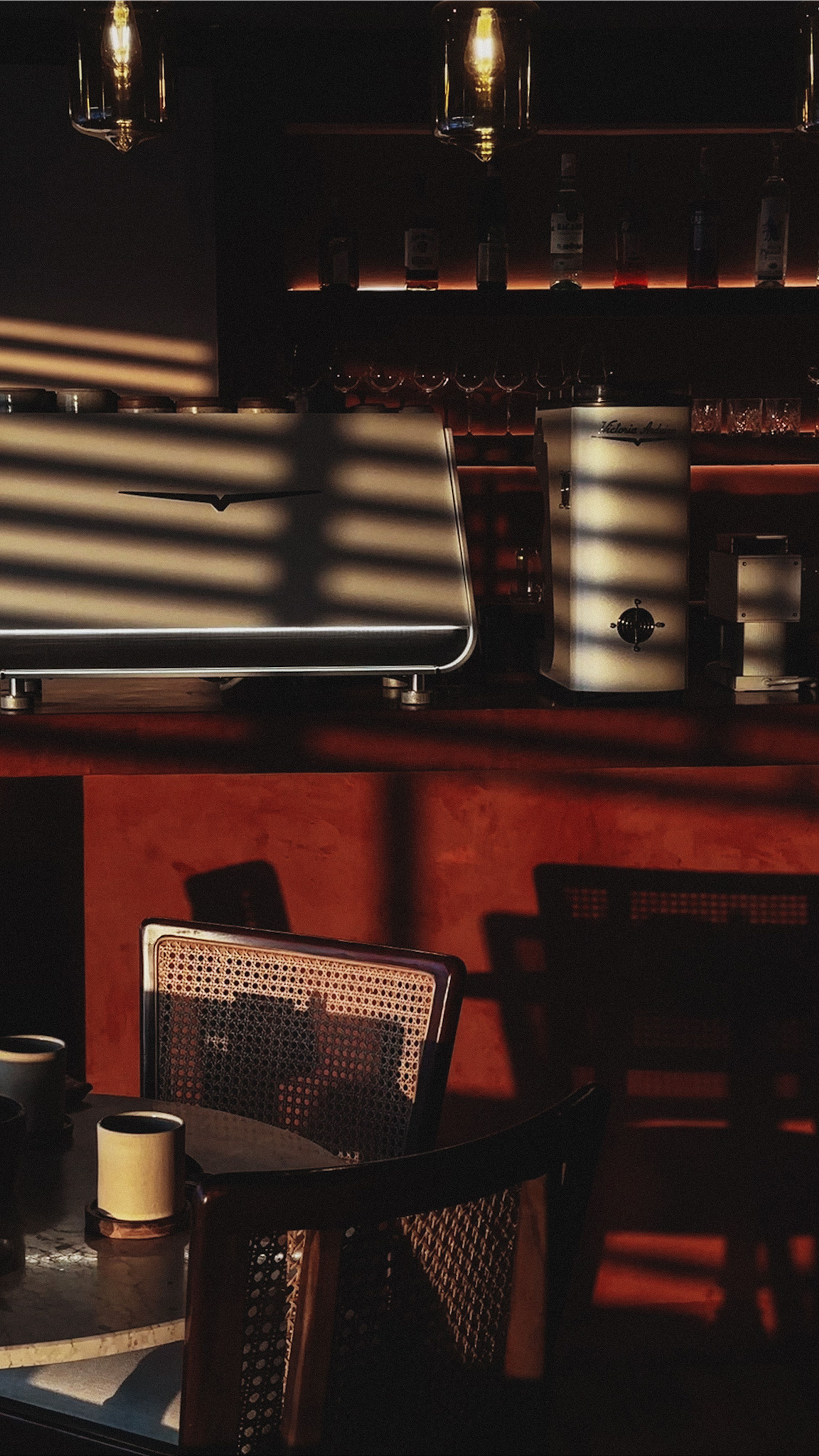 sunday kitchen bar shot, showing shadows with the table and coffee machine in the background