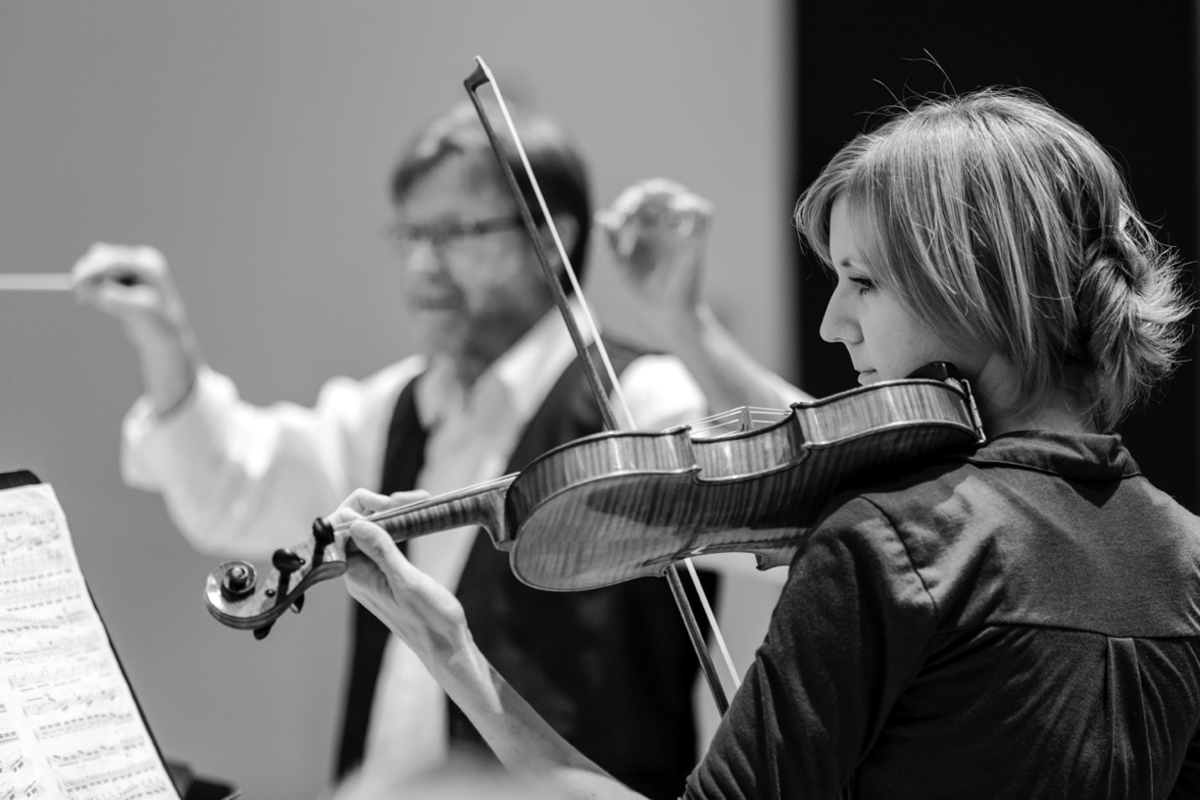 Orchestration — a conductor directs the orchestra