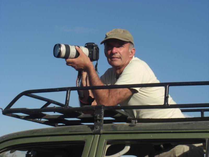 Petter Granli holds a camera with a telephoto lens from the roof of our research vehicle.