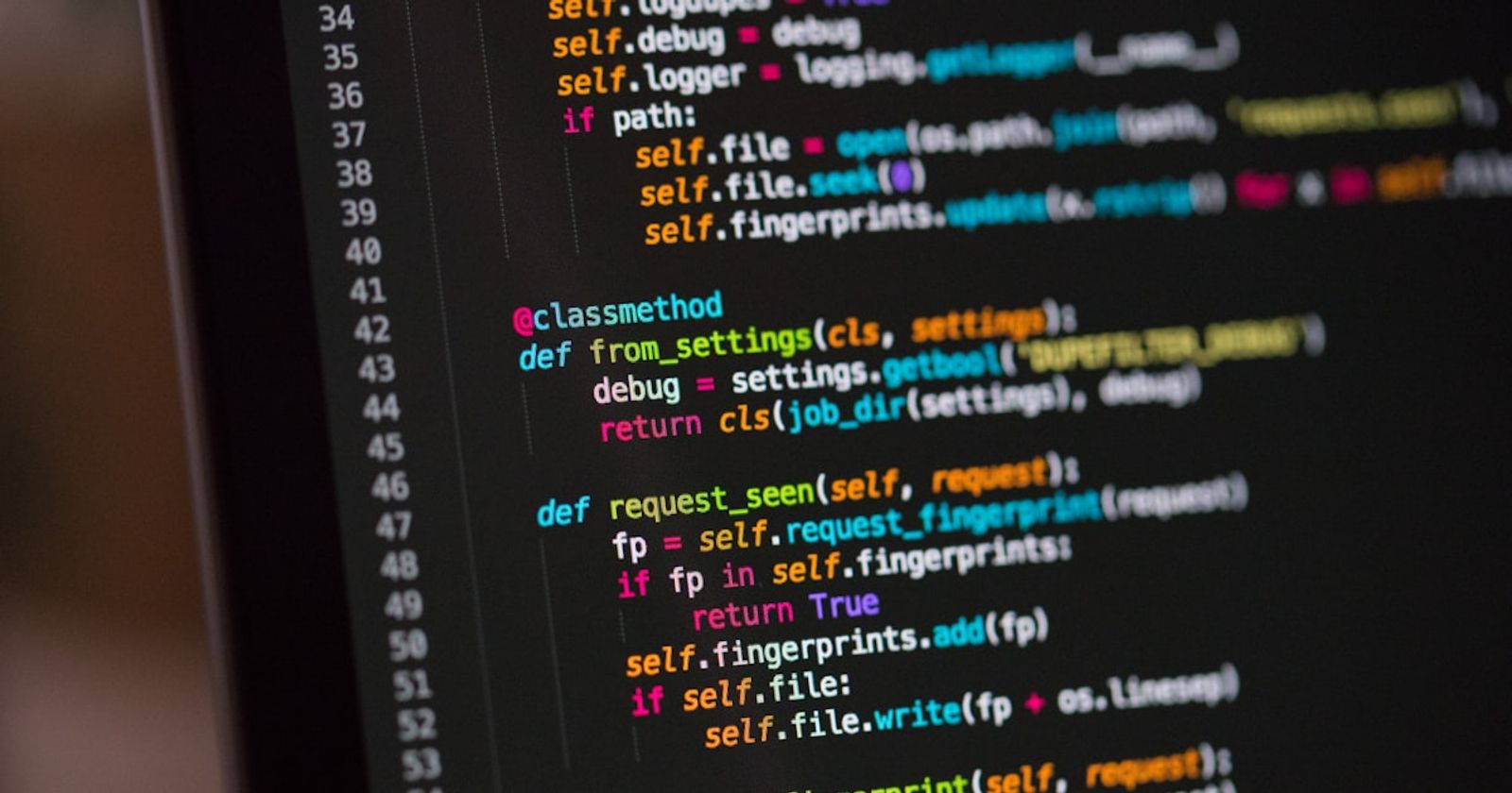 Dense lines of source code on a dark monitor