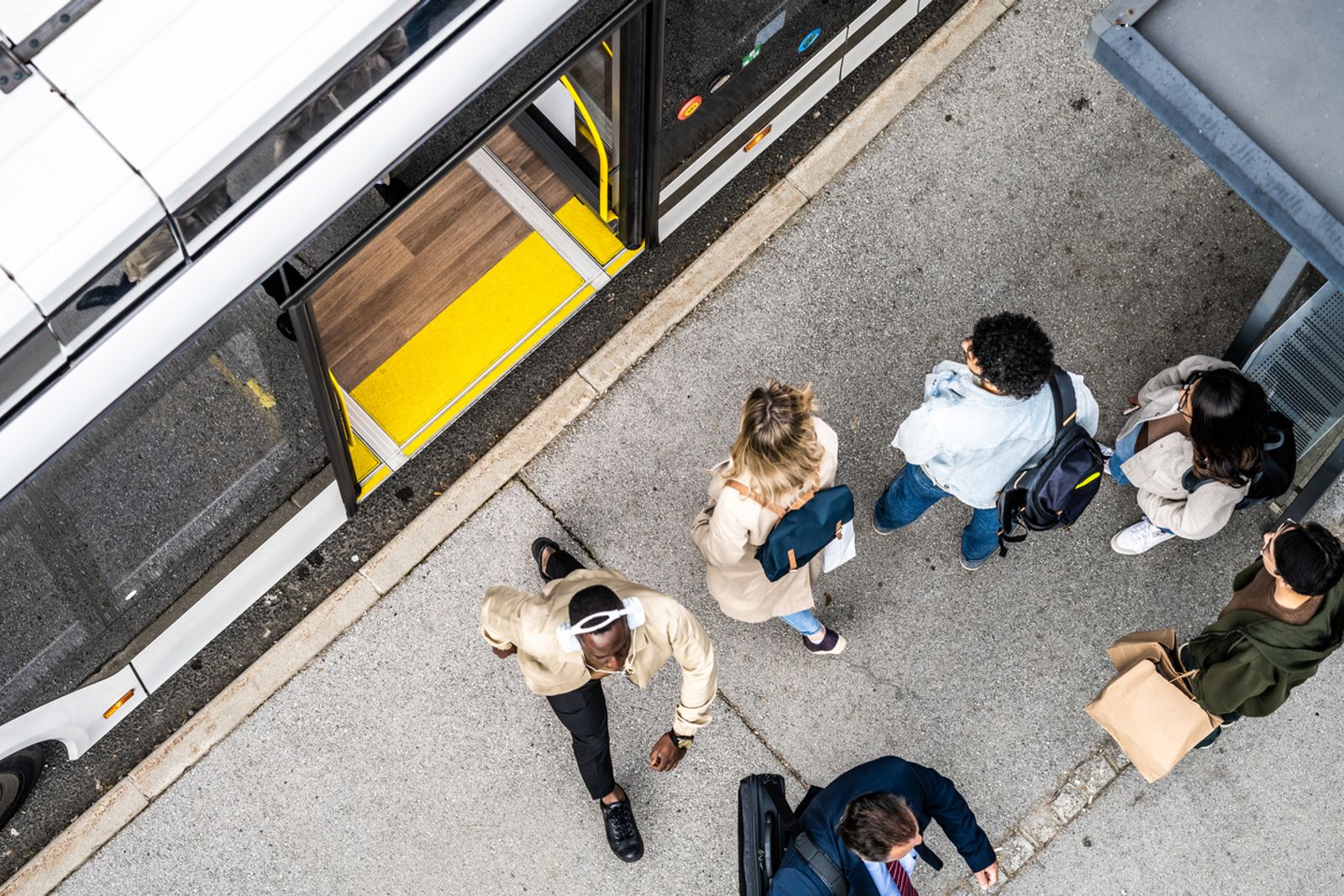 People crowd waiting for city commuter bus at transport stop