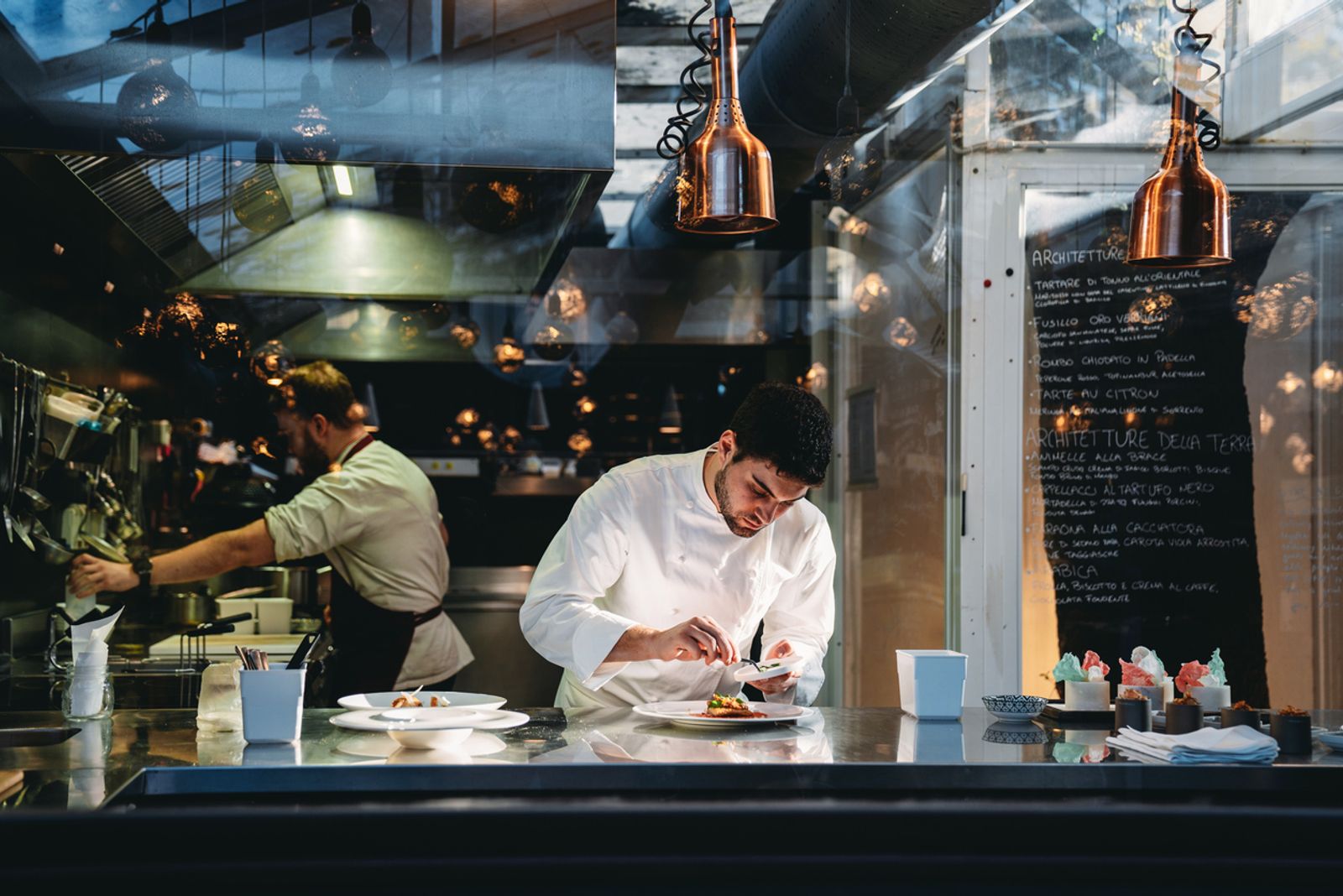 A chef is cooking in his restaurant's kitchen