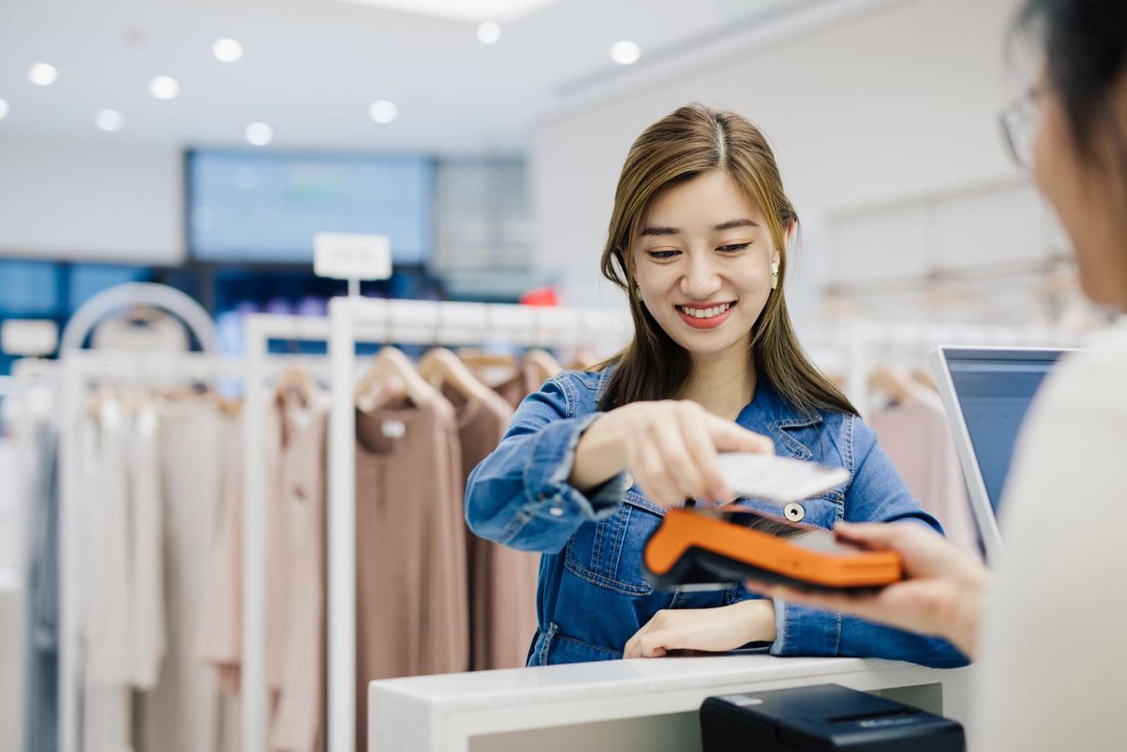 woman using iphone for store checkout