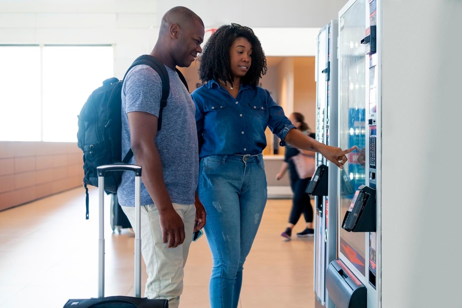 Black couple at an airport vending machine