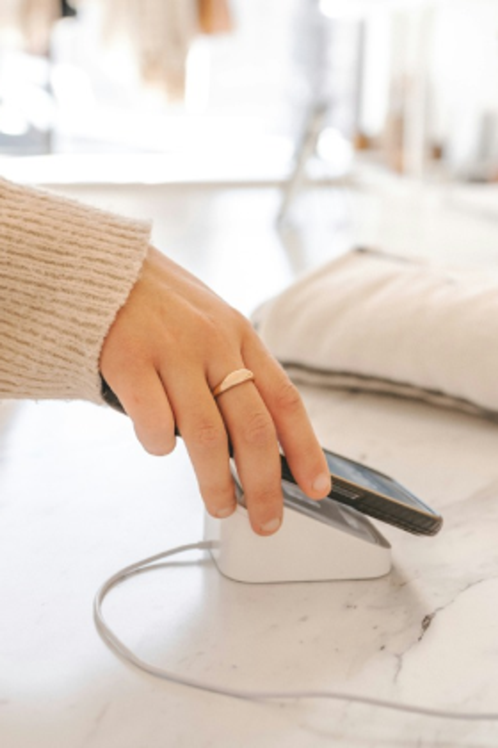 Customer tapping their phone to pay at a point-of-sale device