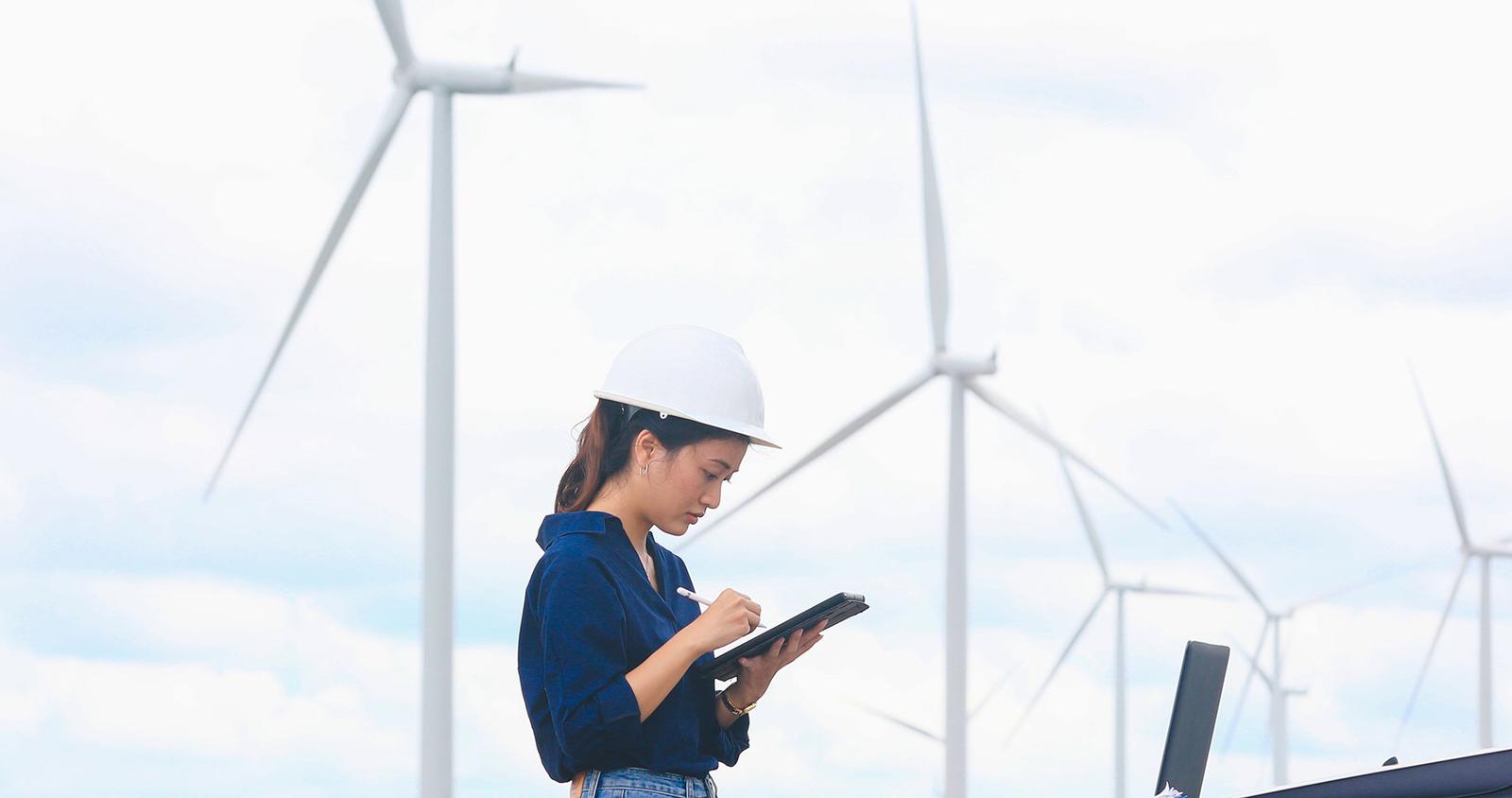 Woman analyzing smart wind turbines