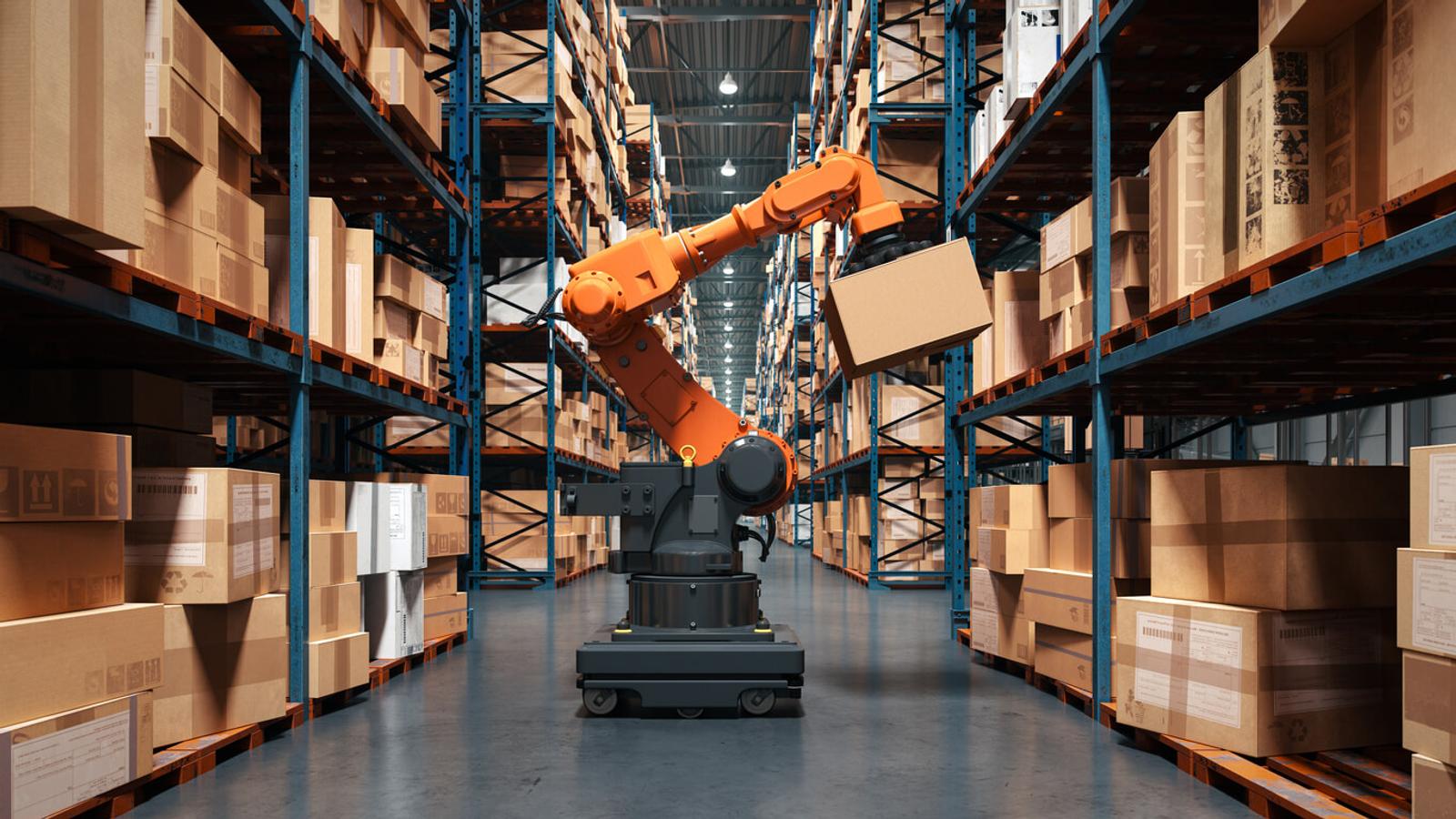 A robotic arm lifts boxes in a warehouse