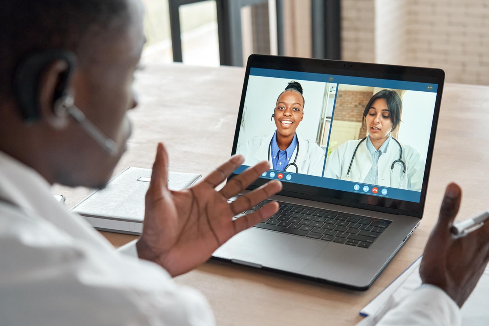 Multicultural doctors team conferencing in video call chat discussing health care learning online during web seminar