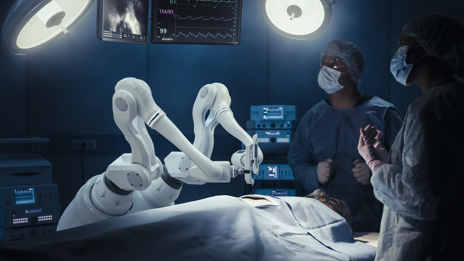 Two Surgeons Observing High-Precision Programmable Automated Robot Arms Operating Patient In High-Tech Hospital