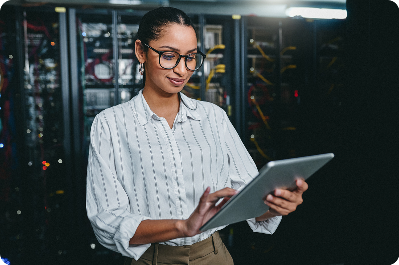 A person on a tablet in a server room