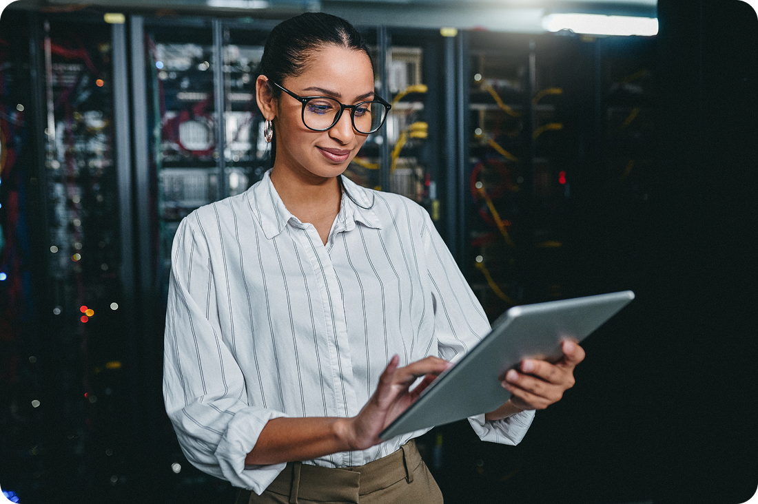 A person on a tablet in a server room