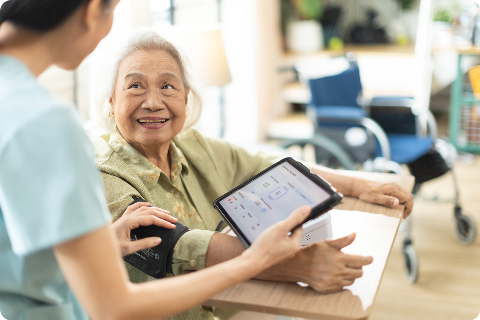 A nurse helps an elderly patient with a blood pressure cuff