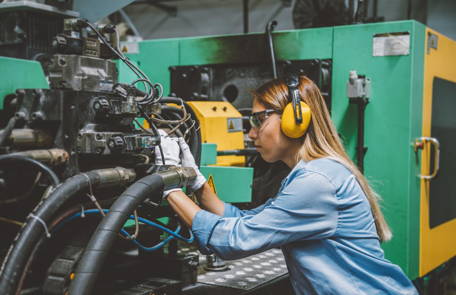 Professional woman technical worker working with production line machine