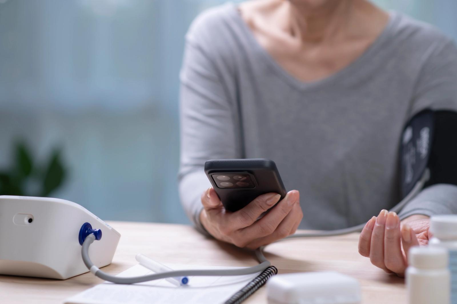 woman taking blood pressure test on phone