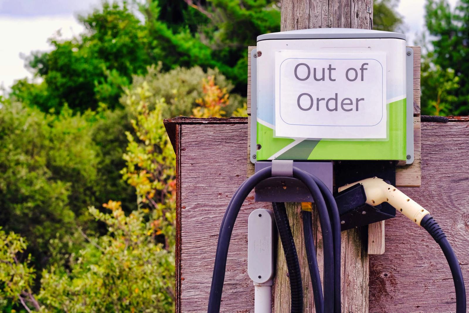 An EV charging station with an "out of order" sign