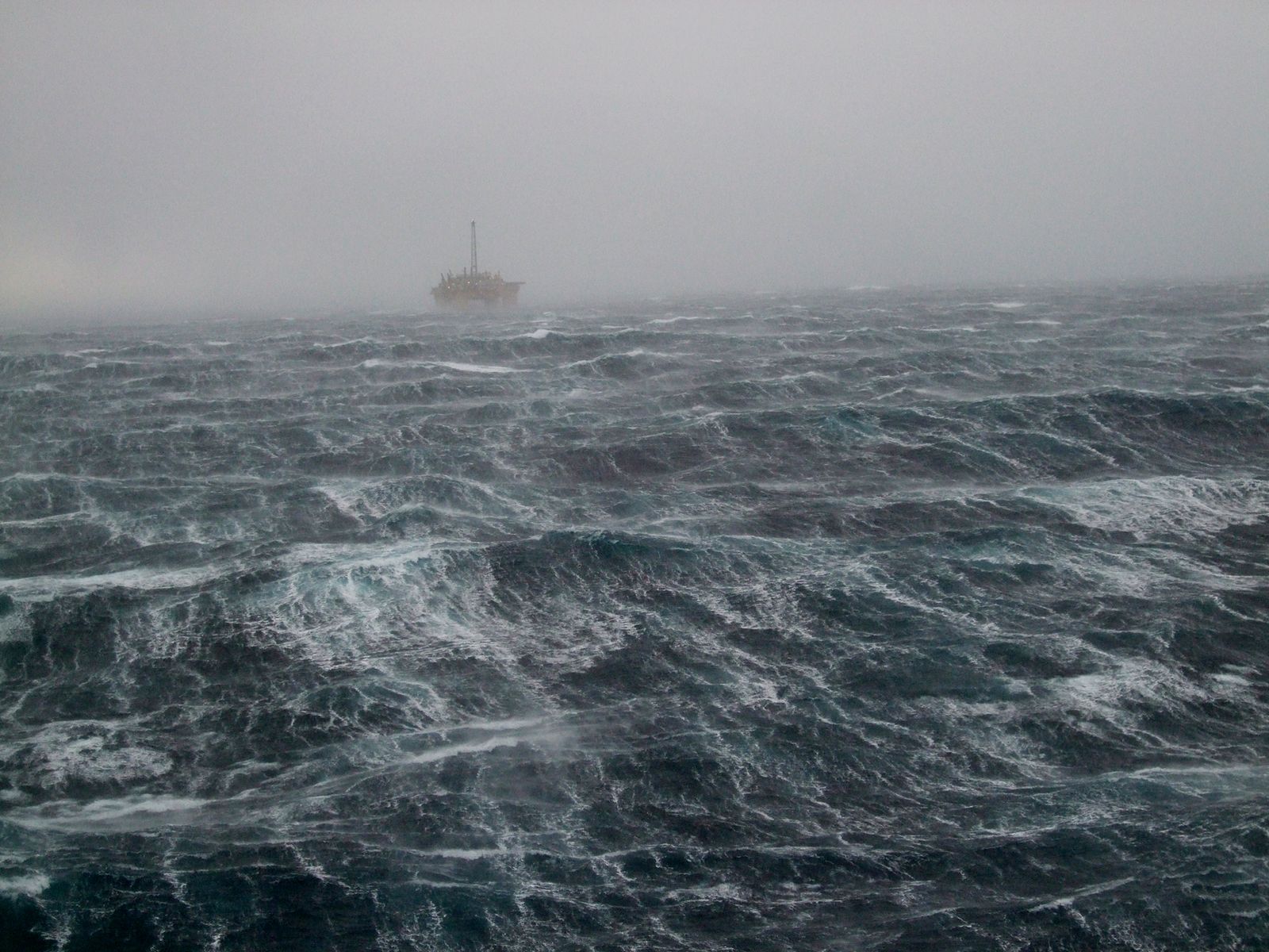 oilrig on the horizon during a winterstorm in the North Sea