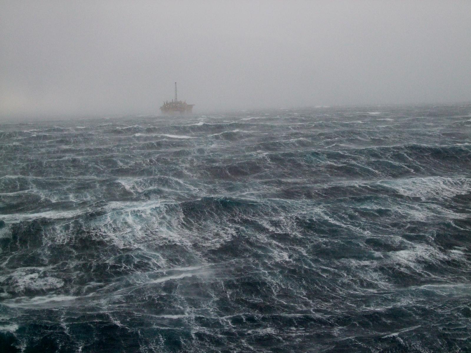 oilrig on the horizon during a winterstorm in the North Sea