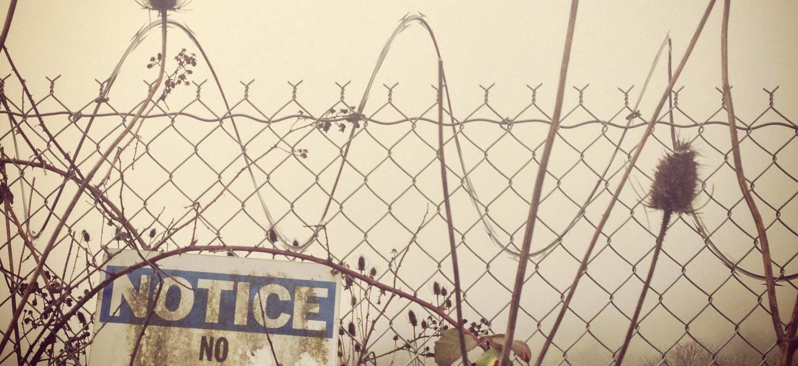 Fence with notice sign